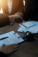 concept of justice and law A male judge in the courtroom on a wooden table and a male counselor or lawyer working in the office. Law, advice and justice concepts. photo