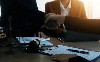 concept of justice and law A male judge in the courtroom on a wooden table and a male counselor or lawyer working in the office. Law, advice and justice concepts. photo