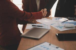 Close up of a team of business people having a meeting to analyze data for a marketing plan. photo