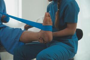 Physical therapists work with patients in close-up clinics. The concept of rehabilitation of physical health, the doctor gives advice to the patient. Ankle problems and muscle injuries photo