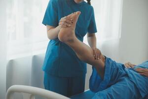 Physical therapists work with patients in close-up clinics. The concept of rehabilitation of physical health, the doctor gives advice to the patient. Ankle problems and muscle injuries photo