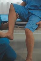 Physical therapists work with patients in close-up clinics. The concept of rehabilitation of physical health, the doctor gives advice to the patient. Ankle problems and muscle injuries photo