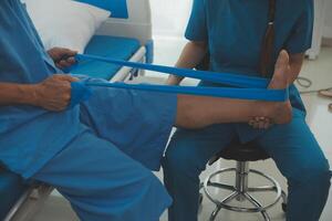 Physical therapists work with patients in close-up clinics. The concept of rehabilitation of physical health, the doctor gives advice to the patient. Ankle problems and muscle injuries photo