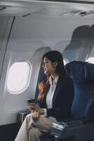 Asian woman sitting in a seat in airplane and looking out the window going on a trip vacation travel concept.Capture the allure of wanderlust with this stunning image photo