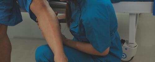 Physical therapists work with patients in close-up clinics. The concept of rehabilitation of physical health, the doctor gives advice to the patient. Ankle problems and muscle injuries photo