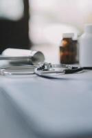 Health care billing statement with stethoscope, bottle of medicine for doctor's work in medical center stone background. photo
