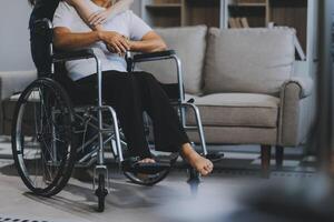 Asian physiotherapist helping elderly woman patient stretching arm during exercise correct with dumbbell in hand during training hand with patient Back problems in garden. Nursing home hospital photo