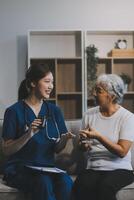 Doctor consulting with patient discussing something and Presenting results on report, Medicine and health care concept. photo