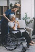 Asian physiotherapist helping elderly woman patient stretching arm during exercise correct with dumbbell in hand during training hand with patient Back problems in garden. Nursing home hospital photo