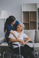 Asian physiotherapist helping elderly woman patient stretching arm during exercise correct with dumbbell in hand during training hand with patient Back problems in garden. Nursing home hospital photo