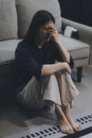 A woman with a cold with pills is treated at home chooses which drugs to take and self-medicates, checks the expiration date while sitting on the couch at home photo