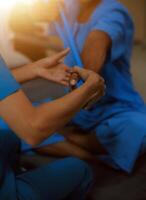 Professional physical therapist examines and cares for a young man in a physical therapy center, treating muscles and injuries of a man in a hospital. photo