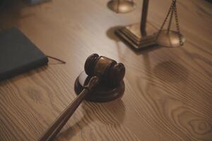 Judge gavel with Justice lawyers having team meeting at law firm background. Concepts of Law and Legal services. photo