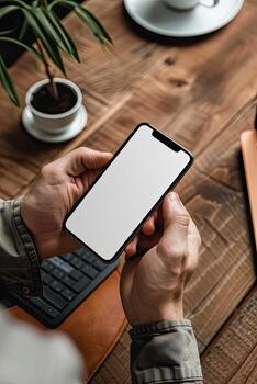 Man holding smartphone with blank screen in office. Mockup for your design photo
