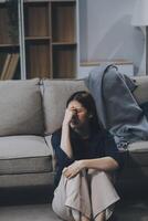 A woman with a cold with pills is treated at home chooses which drugs to take and self-medicates, checks the expiration date while sitting on the couch at home photo