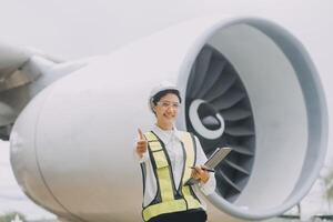 Technician fixing the engine of the airplane,Female aerospace engineering checking aircraft engines,Asian mechanic maintenance inspects plane engine photo