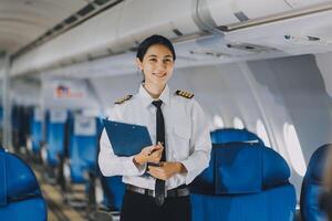 Asian woman working and planning on an airplane. Asian woman reading a book while sitting on an airplane. photo