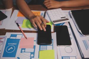 The designer team is designing the uxui system to make the uxui system work well on new phones and support system updates. Website development concept UI UX front end designer photo