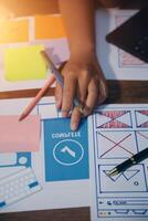 The designer team is designing the uxui system to make the uxui system work well on new phones and support system updates. Website development concept UI UX front end designer photo