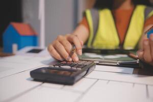 Female architect working at home She looked at the blueprint. photo