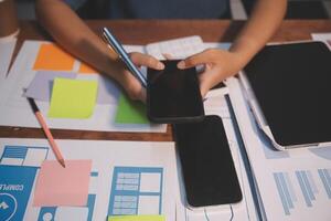 The designer team is designing the uxui system to make the uxui system work well on new phones and support system updates. Website development concept UI UX front end designer photo