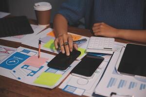 The designer team is designing the uxui system to make the uxui system work well on new phones and support system updates. Website development concept UI UX front end designer photo