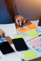 The designer team is designing the uxui system to make the uxui system work well on new phones and support system updates. Website development concept UI UX front end designer photo