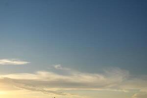 Cloudy Blue Sky in the evening light. Evening light blue sky with white clouds photo