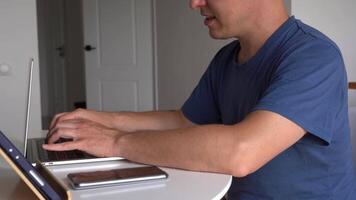 Close-up of a man's hands typing on a keyboard, looking for information. A freelance copywriter is working on a project. The concept of remote work. video