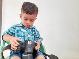 portrait of a little boy studying photography photo
