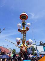 Pariaman, Indonesia - July 21, 2024. people flocked to take photos near the Tabuik Statue before the cultural event started