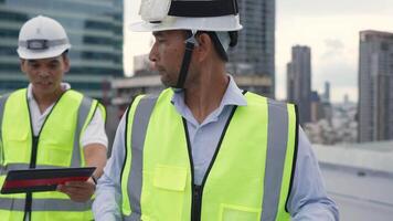 Engineer and city skyline with a crane in the background. The crane is in the middle of the city and is surrounded by tall buildings. video