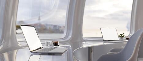 Two laptops on a modern metallic chrome curved table in an office with a minimal spaceship theme. photo
