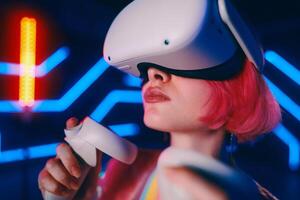 Young woman playing VR game in neon room. photo