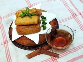 Traditional Indonesian snack Sosis Solo from Central Java, made from savory flour dough and filled with delicious minced chicken or beef then fried. More delicious if eaten with green cayenne pepper photo