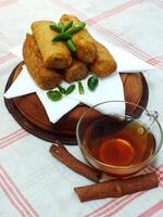 Traditional Indonesian snack Sosis Solo from Central Java, made from savory flour dough and filled with delicious minced chicken or beef then fried. More delicious if eaten with green cayenne pepper photo