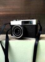 old film camera gear isolated on a dark textured background. retro photography vintage. nostalgic vacation historical moment photo