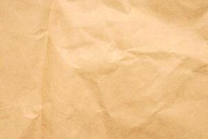 Abstract crumpled and creased recycle brown paper texture background photo
