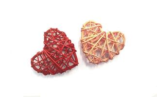 Two wicker hearts - pink and red isolated on a white background, as a symbol of romantic relationships, love. Template, layout for Valentine's Day February 14. photo