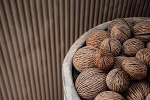 Top view of a Cerbera odollam seeds or pong pong seeds from suicide tree with a brown blank background. Close up of pong pong plant seeds showing beautiful patterns used for garden decoration. photo