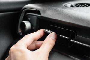 Close up the driver hand adjusts the wind direction of the air vent in the modern car, button direction adjustment of the air conditioning system in the car, Automotive air conditioning concept 2024. photo