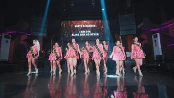 Dancers on stage with colorful lighting at a live performance event. video