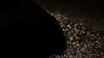Chia seeds food rotating with a intimate light and black background video