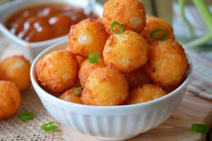 Bowl overflowing with delicious fried cheese balls appetizer photo