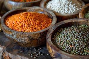 Bowls overflowing with red and green lentils on rustic wooden table photo