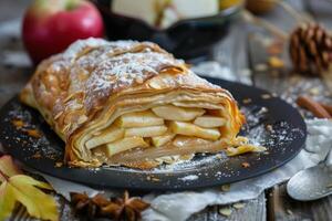 Homemade apple strudel on rustic table photo