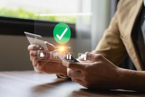 Person Making Online Payment with Credit Card on Laptop, Holographic Interface Showing Payment Successful and Shopping Icons, Representing E-commerce and Digital Transactions photo