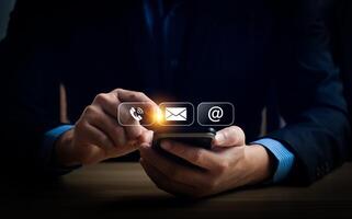 Man Using Smartphone to Access Communication Icons for Call, Email, and Internet, Representing Modern Digital Connectivity and Technology in Everyday Life photo