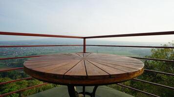 round wooden table with a wide view photo