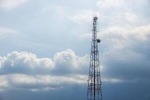 5G Telecom signal tower. Telecommunication Tower on blue cloudy storm sky for background, Technology Mobile Network Concept. photo